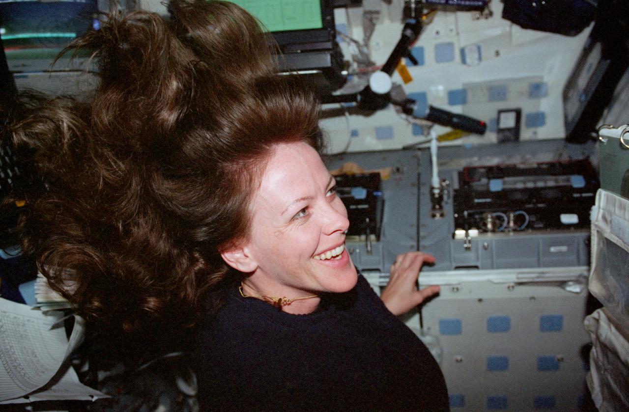 STS099-329-019 (11-22 February 2000) --- Astronaut Janet L. Kavandi, mission specialist, appears joyous over the success of the Shuttle Radar Topography Mission (SRTM) and other experiments on the flight deck of the Space Shuttle Endeavour. The Red Team member is standing beneath an electronic still camera (ESC) mounted in Endeavour's overhead windows. The camera stayed busy throughout the ll-day mission taking vertical imagery of Earth points of opportunity for the EarthKAM project. Students across the United States and in France, Germany and Japan took photos throughout the STS-99 mission. And they are using these new photos, plus all the images already available in the EarthKAM system, to enhance their classroom learning in Earth and space science, social studies, geography, mathematics and more.