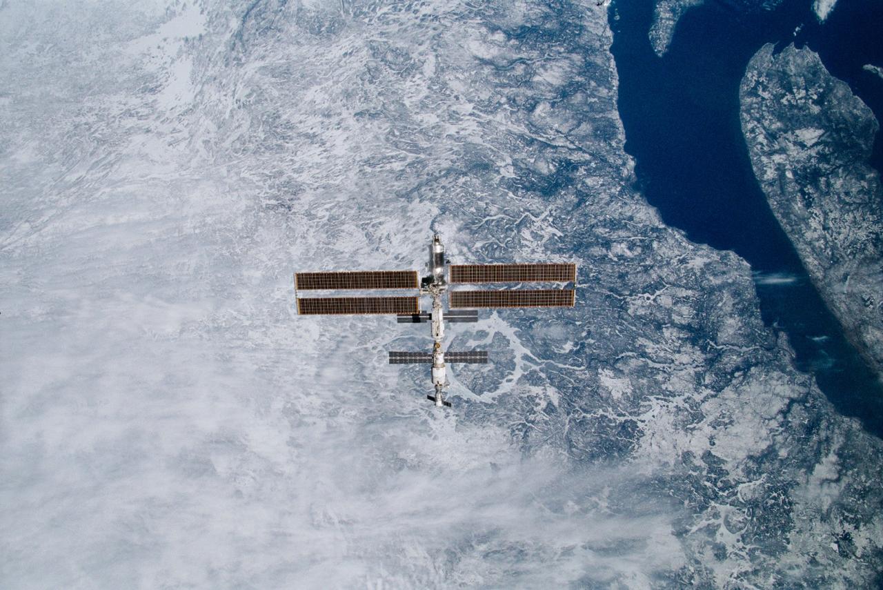 STS100-332-011 (29 April 2001) --- Backdropped against the topography of the Canadian province of Quebec, the International Space Station (ISS) was photographed following separation from the Space Shuttle Endeavour. An impact feature known as the Manicouagan Reservoir, is almost directly beneath the orbital outpost. The 35mm frame was exposed by one of the STS-100 crewmembers onboard the shuttle.