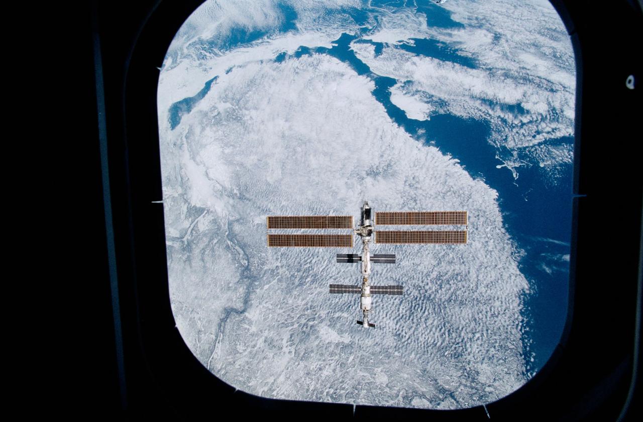 STS100-332-020 (29 April 2001) --- Backdropped against the topography of the Canadian province of Quebec, the International Space Station (ISS) was photographed through an aft flight deck window following separation from the Space Shuttle Endeavour. The 35mm frame was exposed by one of the STS-100 crewmembers onboard the shuttle.
