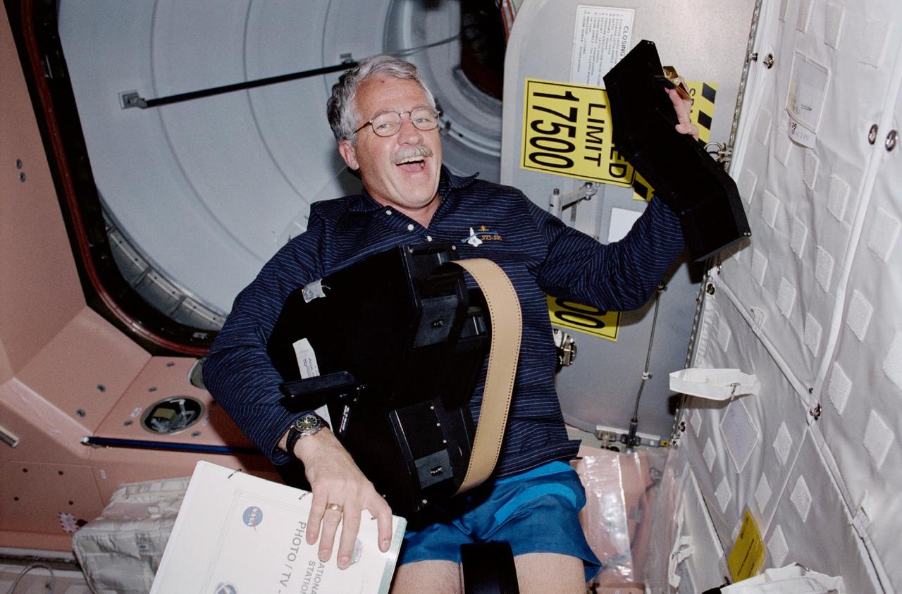 STS100-342-035 (19 April-1 May 2001) --- Astronaut John L. Phillips, mission specialist, works with the IMAX camera on the International Space Station (ISS). Phillips and his STS-100 crew mates transferred supplies to the station and recorded video, motion picture and still photography of their activities, including interaction with the Expedition Two crewmembers.