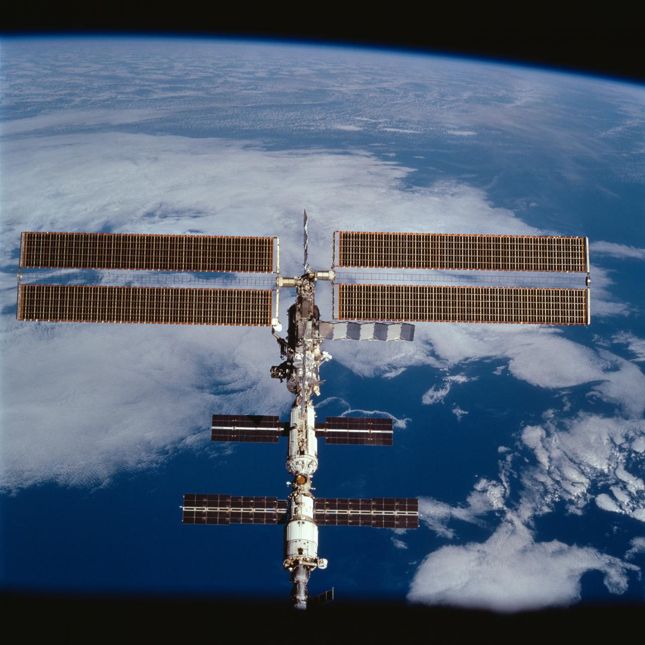 STS100-710-130 (29 April 2001) --- Backdropped against the blue and white Earth, the International Space Station (ISS) was photographed following separation from the Space Shuttle Endeavour. The 70mm frame was exposed by one of the STS-100 crewmembers onboard the shuttle.