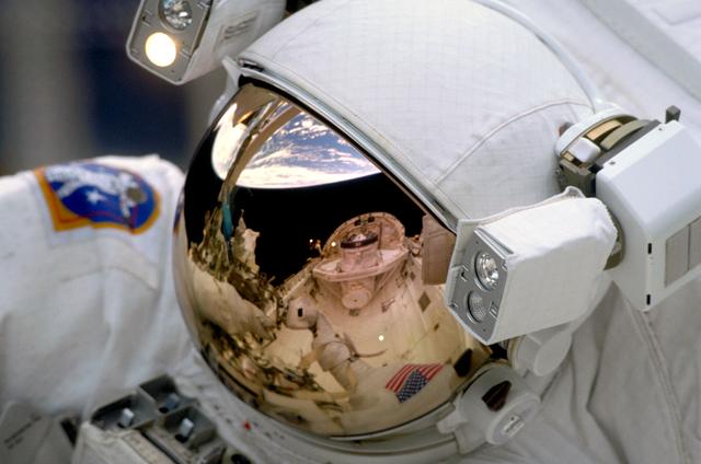 NASA image: Reflection of payload bay in EMU helmet during EVA