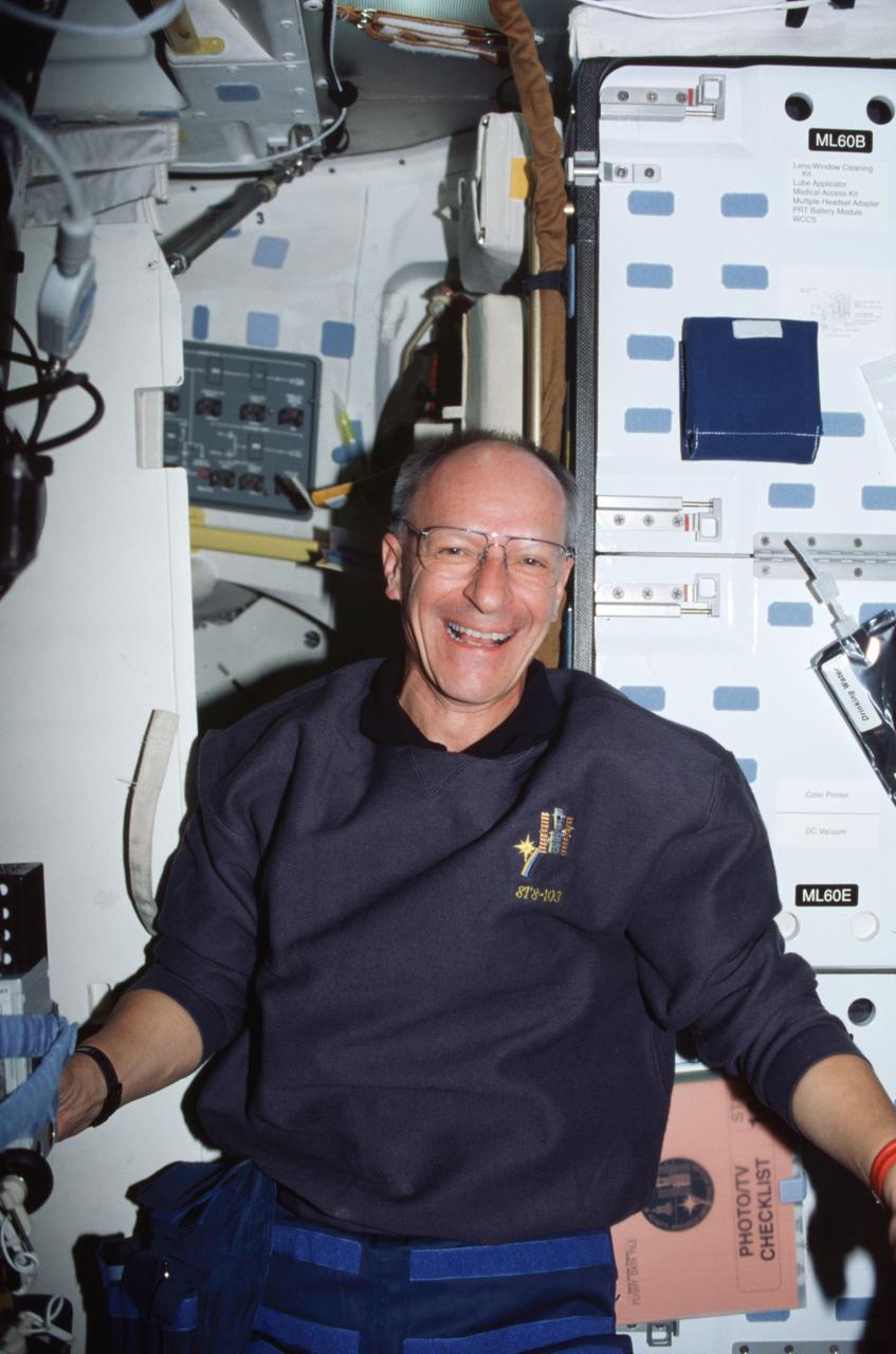 STS103-329-025 (19-27 December 1999) ---.Astronaut Claude Nicollier, mission specialist representing the European Space Agency (ESA), on Discovery's mid deck prior to a space walk in the weightlessness of space.