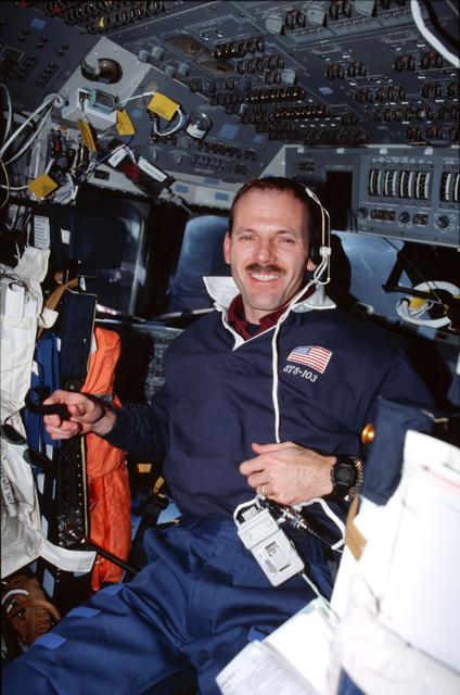 NASA image: Various views of the STS-103 crew on the flight deck