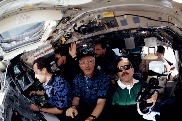 NASA image: Various view with fish-eye lens of STS-103 crew on aft flight deck
