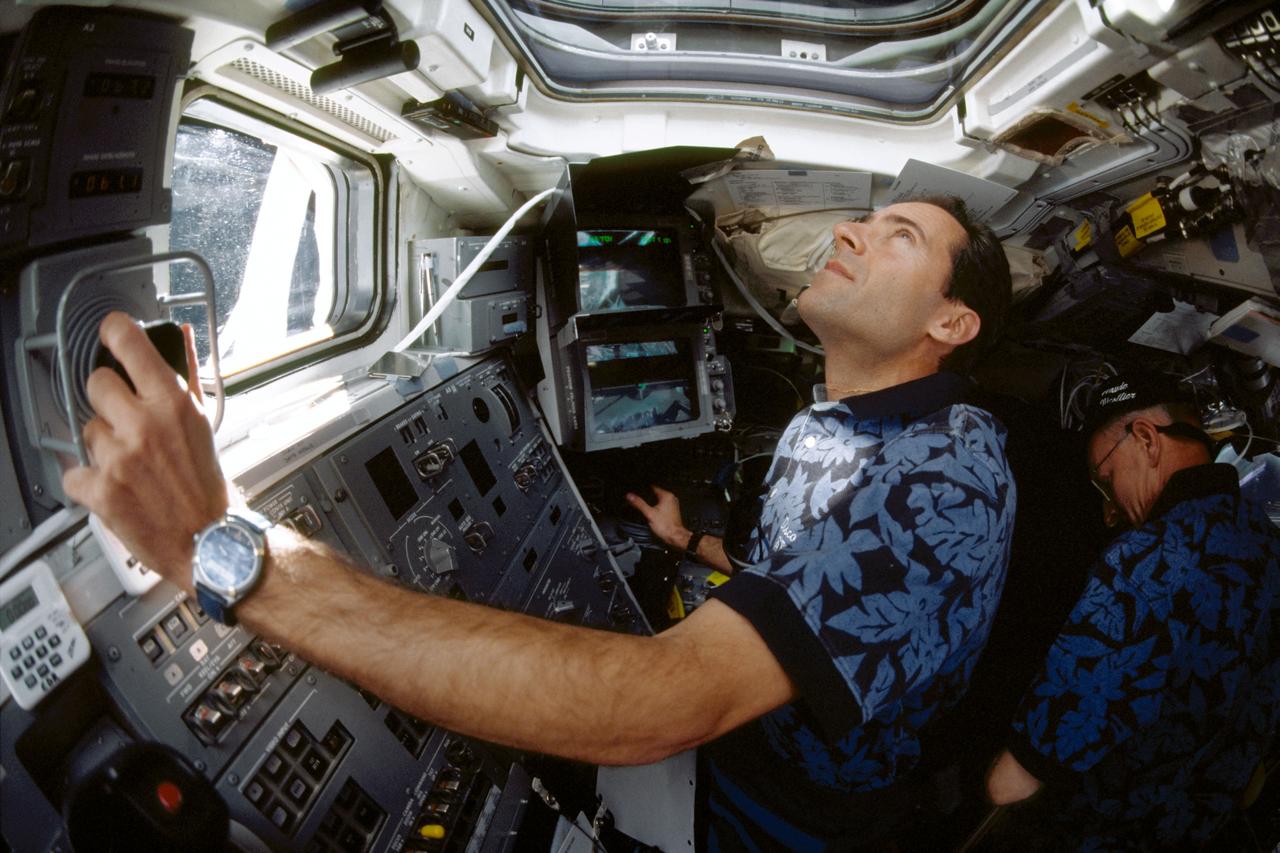 STS103-375-027 (19 - 27 December 1999).--- Astronaut Jean-Francois Clervoy, mission specialist representing the European Space Agency (ESA), controls Discovery's remote manipulator system (RMS) robot arm during operations.with the Hubble Space Telescope (HST).