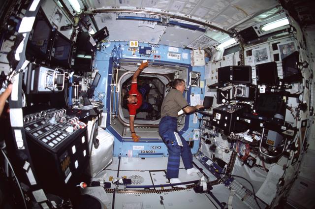 NASA image: Horowitz floats into the ISS U.S. Laboratory/Destiny module where Voss is typing