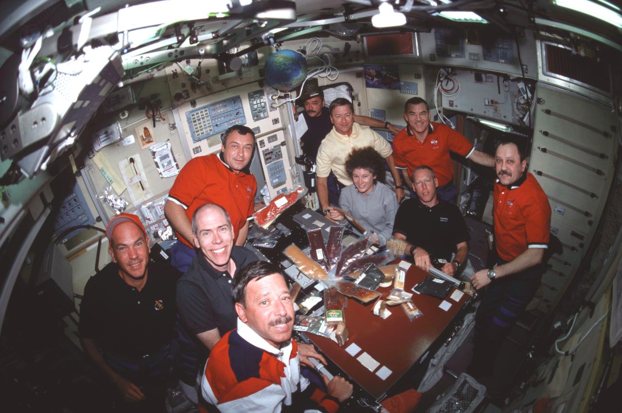 STS105-306-005 (15 August 2001) --- Seven astronauts and three cosmonauts representing Rosaviakosmos are just about to share a meal in the Zvezda Service Module on the International Space Station (ISS) in this &quot;fish-eye&quot; lens view. Positioned  at the table (counter-clockwise from the foreground) are Scott J. Horowitz, STS-105 mission commander; Daniel T. Barry, STS-105 mission specialist; Frederick W. (Rick) Sturckow, STS-105 pilot; Vladimir N. Dezhurov, Expedition Three flight engineer; Susan J. Helms, Expedition Two flight engineer; Patrick G. Forrester, mission specialist; and  Yury V. Usachev, Expedition Two commander. In background, from the left, are Mikhail Tyurin, Expedition Three flight engineer; Frank L. Culbertson, Jr., Expedition Three commander; and James S. Voss, Expedition Two flight engineer.  Dezhurov, Tyurin and Usachev represent Rosaviakosmos.
