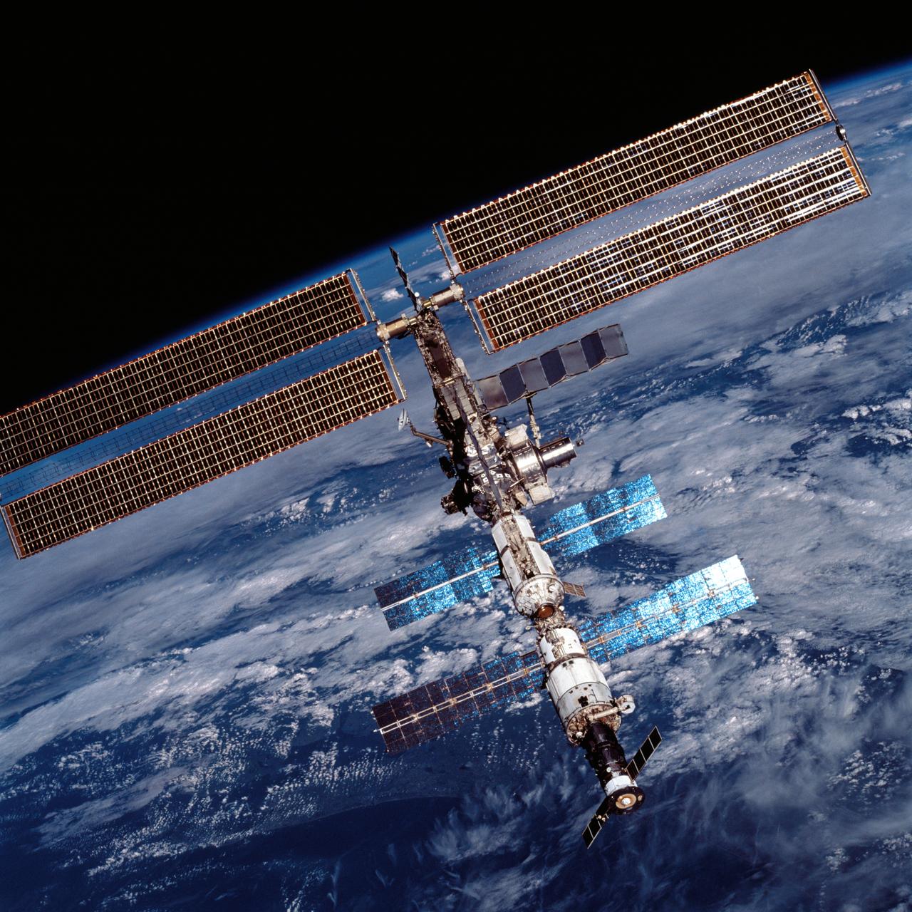 STS105-707-022 (20 August 2001) --- Backdropped by the darkness of space and the blue Earth at its horizon, the International Space Station (ISS) was photographed by one of the astronauts aboard the Discovery after undocking from the station which took place at 9:52 a.m. (CDT), August 20, 2001.