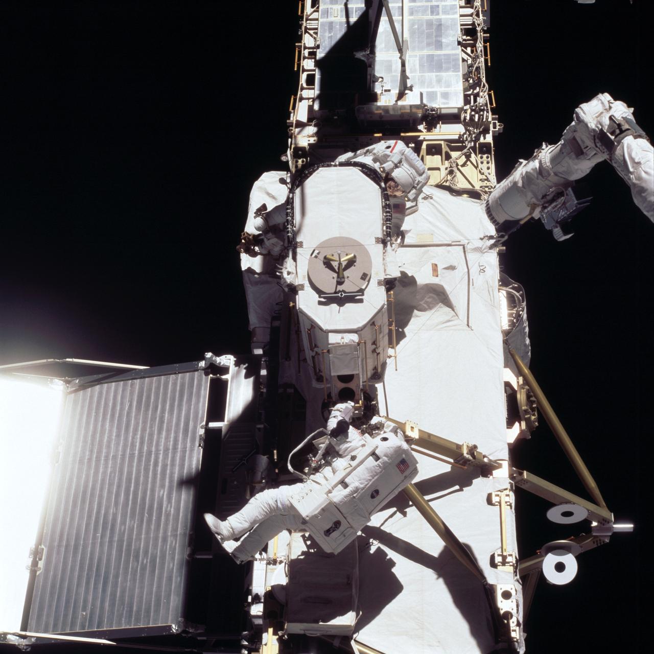STS105-725-062 (16 August 2001) --- Astronaut Daniel T. Barry (upper left) moves in close to the Early Ammonia Servicer (EAS) package as astronaut Patrick G. Forrester (right) looks on. The two STS-105 mission specialists were in the midst of the first of two scheduled space walks on the current mission at the International Space Station (ISS).
