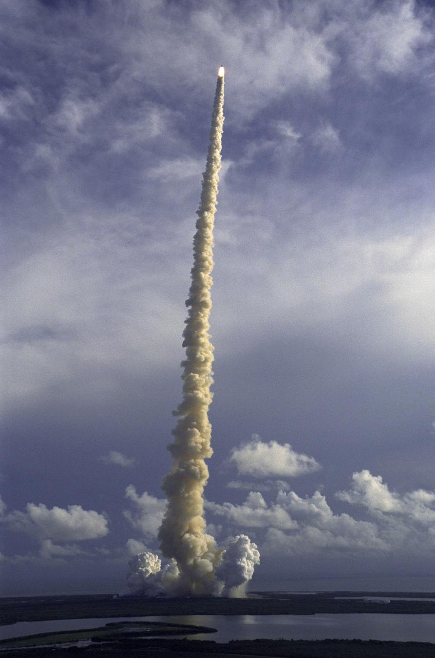 STS106-S-005 (8 September 2000) --- This distant view of the STS-106 liftoff was photographed across marsh waters around Mosquito Lagoon and Banana Creek, looking toward the Atlantic Ocean.  The perfect on-time liftoff of the Space Shuttle Atlantis occurred at 8:45:47 a.m. (EDT), September 8, 2000.  Onboard the shuttle were astronauts Terrence W. Wilcutt, Scott D. Altman, Edward T. Lu,  Richard A. Mastracchio and Daniel C. Burbank, along with cosmonauts Yuri I. Malenchenko and Boris V. Morukov who represent the Russian Aviation and Space Agency.