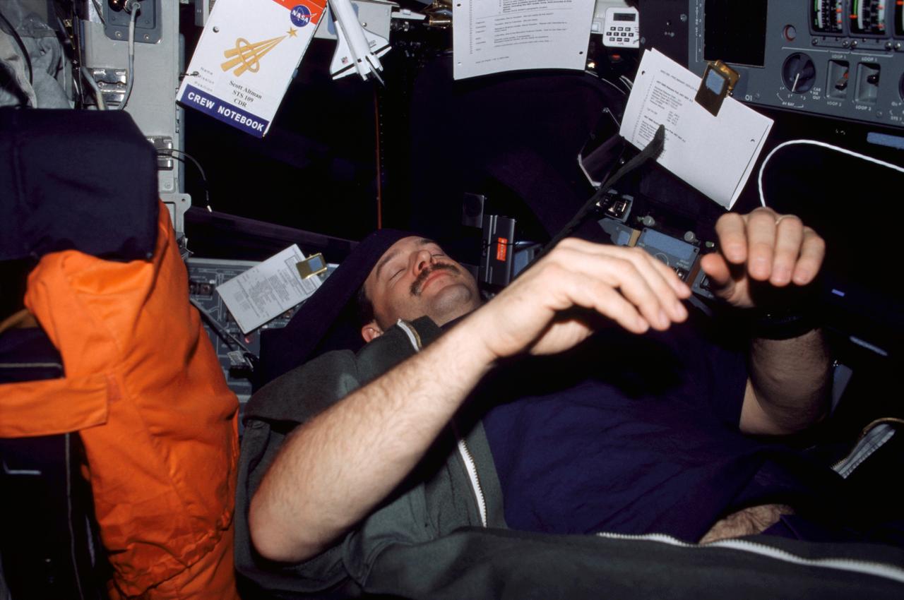 STS109-335-020 (1-12 March 2002) --- Astronaut Scott D. Altman, STS-109 mission commander, sleeps on the flight deck of the Space Shuttle Columbia.
