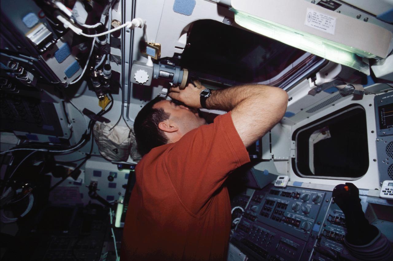 STS109-346-002 (1-12 March 2002) --- Astronaut Scott D. Altman, STS-109 mission commander, looks out an overhead window on the aft flight deck of the Space Shuttle Columbia.
