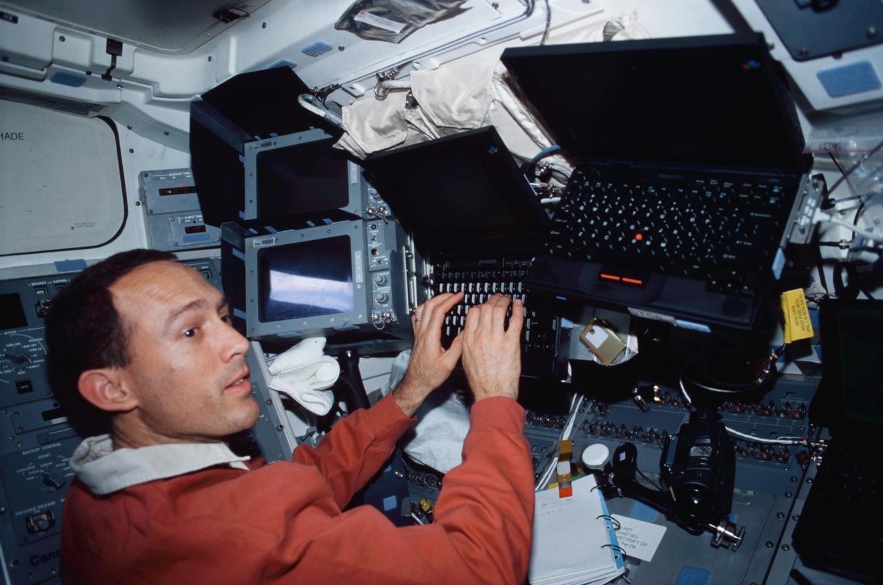 STS109-406-026 (1-12 March 2002) --- Astronaut James H. Newman, STS-109 mission specialist, works with Payload and General Support Computers (PGSC) on the mid deck of the Space Shuttle Columbia.