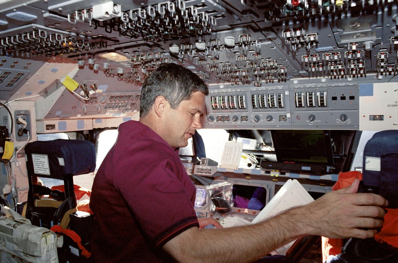 STS111-315-010 (5-19 June 2002) --- Astronaut Paul S. Lockhart, pilot, looks over a checklist while performing a task at the commander's station on the forward flight deck of the Space Shuttle Endeavour.