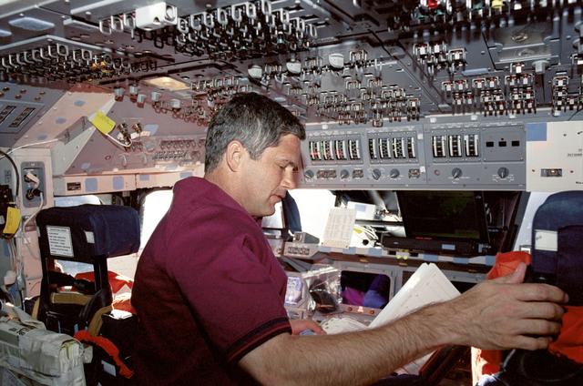 NASA image: Lockhart reads a checklist on Endeavour's FD during STS-111 UF-2
