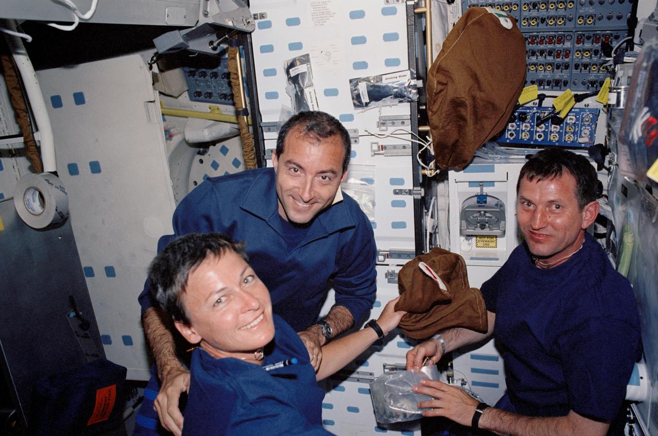 STS111-315-013 (5-19 June 2002) --- Astronauts Peggy A. Whitson (foreground), Expedition Five flight engineer; Philippe Perrin, STS-111 mission specialist; and cosmonaut Sergei Y. Treschev, Expedition Five flight engineer, are photographed on the middeck of the Space Shuttle Endeavour. Perrin represents CNES, the French Space Agency, and Treschev represent Rosaviakosmos.