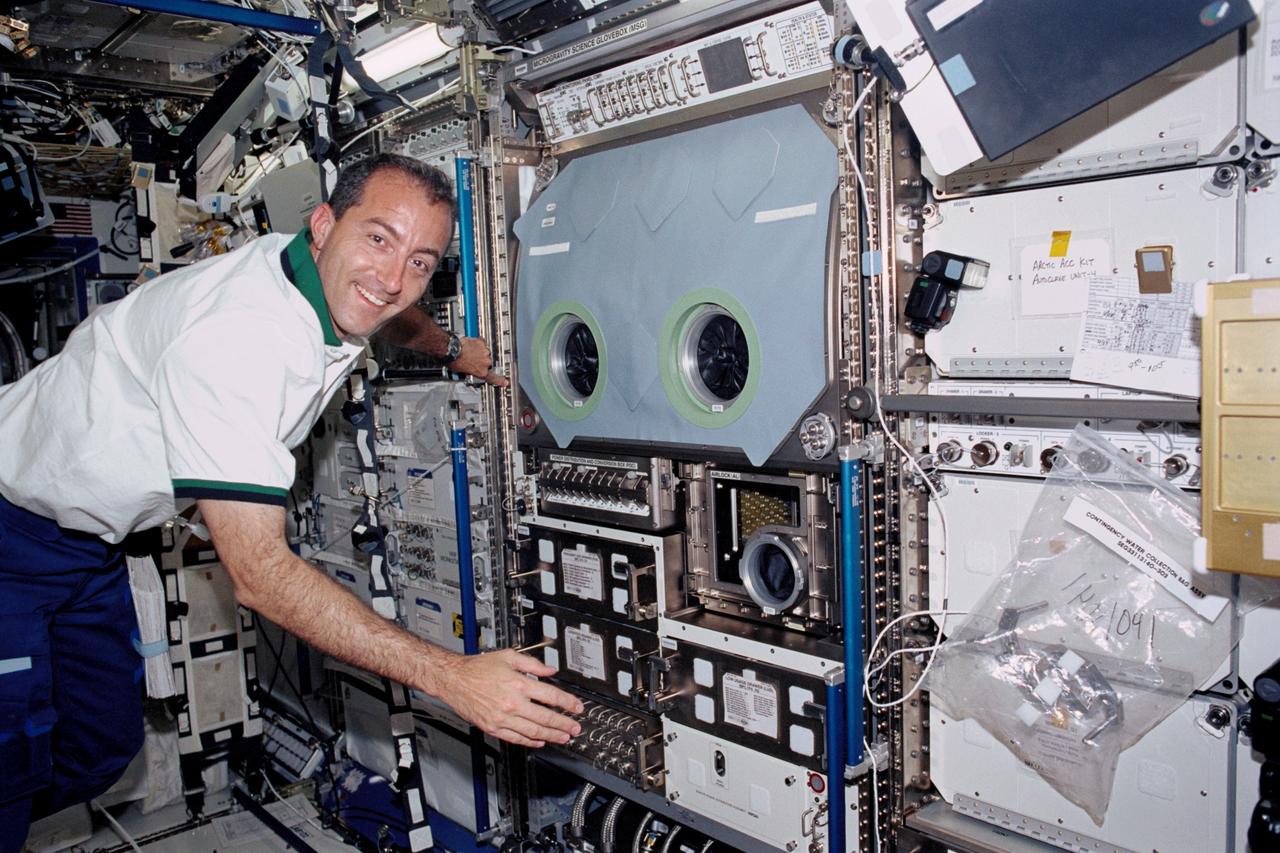 STS111-318-017 (5-19 June 2002) --- Astronaut Philippe Perrin, STS-111 mission specialist, floats near the Microgravity Science Glovebox (MSG) in the Destiny laboratory on the International Space Station (ISS). Perrin represents CNES, the French Space Agency.