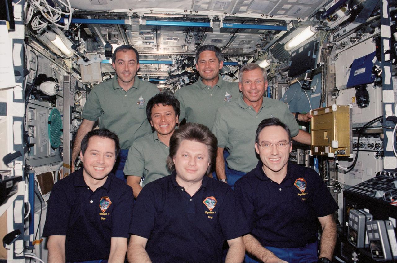 STS111-320-015 (5-19 June 2002) --- The STS-111 (back row) and Expedition Four crewmembers gather for a group photo in the Destiny laboratory on the International Space Station (ISS). The STS-111 crewmembers, from the left, are astronauts Philippe Perrin and Franklin R. Chang-Diaz, both mission specialists; Paul S. Lockhart and Kenneth D. Cockrell, pilot and mission commander, respectively. The Expedition Four crewmembers, from the left, are astronaut Daniel W. Bursch, flight engineer; cosmonaut Yury I. Onufrienko, mission commander; and astronaut Carl E. Walz, flight engineer. Onufrienko represents Rosaviakosmos and Perrin represents CNES, the French Space Agency.