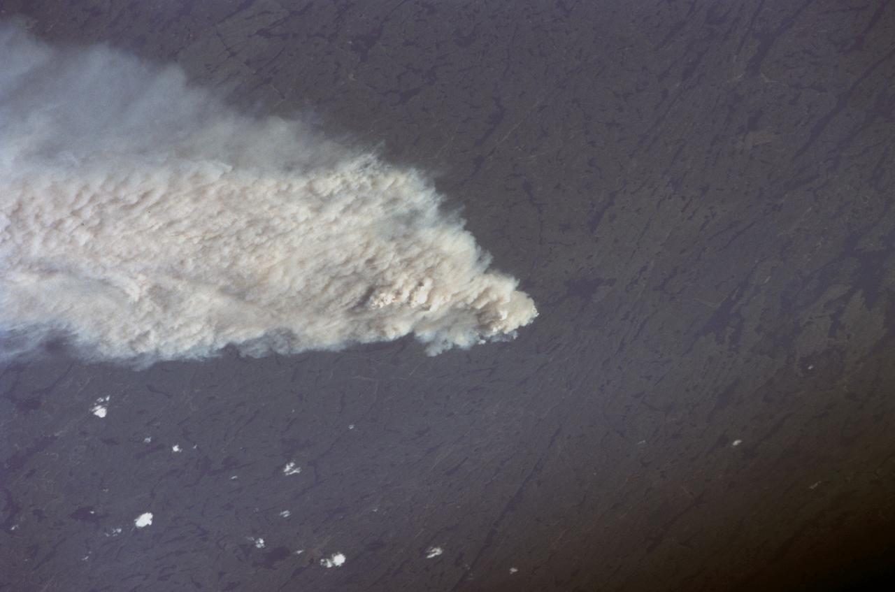 STS111-367-014 (5-19 June 2002) --- This view featuring Canadian forest fires was photographed by the STS-111 crewmembers aboard the Space Shuttle Endeavour. It represents an oblique view northward of one of the numerous fires observed and reported burning in the dry boreal forests of Saskatchewan and Manitoba during the month of June. The location of this one is roughly between Candle Lake, Saskatchewan and Lake Winnepegosis, Manitoba. The Gateway to Astronaut Photography of Earth (link to http://eol.jsc.nasa.gov/sseop/) provides searchable access to other photographs of Earth taken by astronauts.