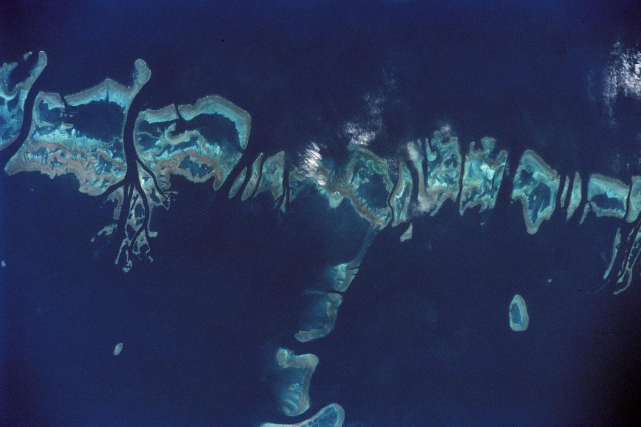 STS111-368-036 (5-19 June 2002) --- This photo, giving detail of the Pompey Island Group in the Southern Great Barrier Reef off Australia, was taken by the STS-111 crewmembers aboard the Space Shuttle Endeavour. Ocean flow between the islands has produced unique wash features in the structures of the island banks. The Gateway to Astronaut Photography of Earth (link to http://eol.jsc.nasa.gov/sseop/) provides searchable access to other photographs of Earth taken by astronauts.