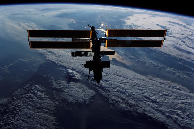 NASA image: Zenith view of the ISS silhouetted against Earth's limb taken during STS-111 UF-2 Flyaround