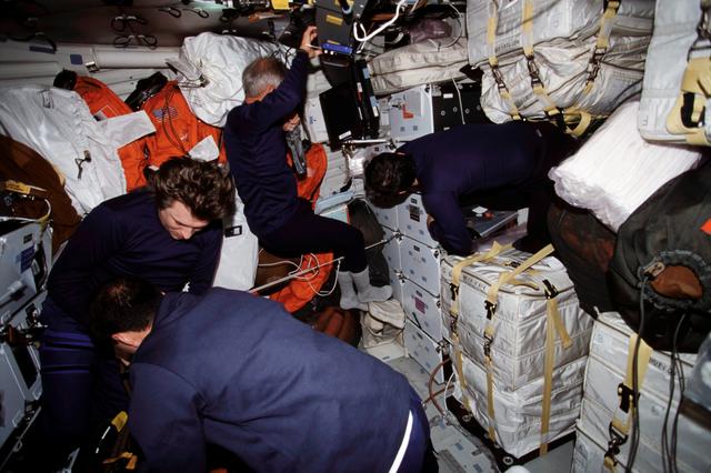 NASA image: STS-111 UF-2 and EXP 4 Crewmembers work to secure Endeavour's MDK for landing