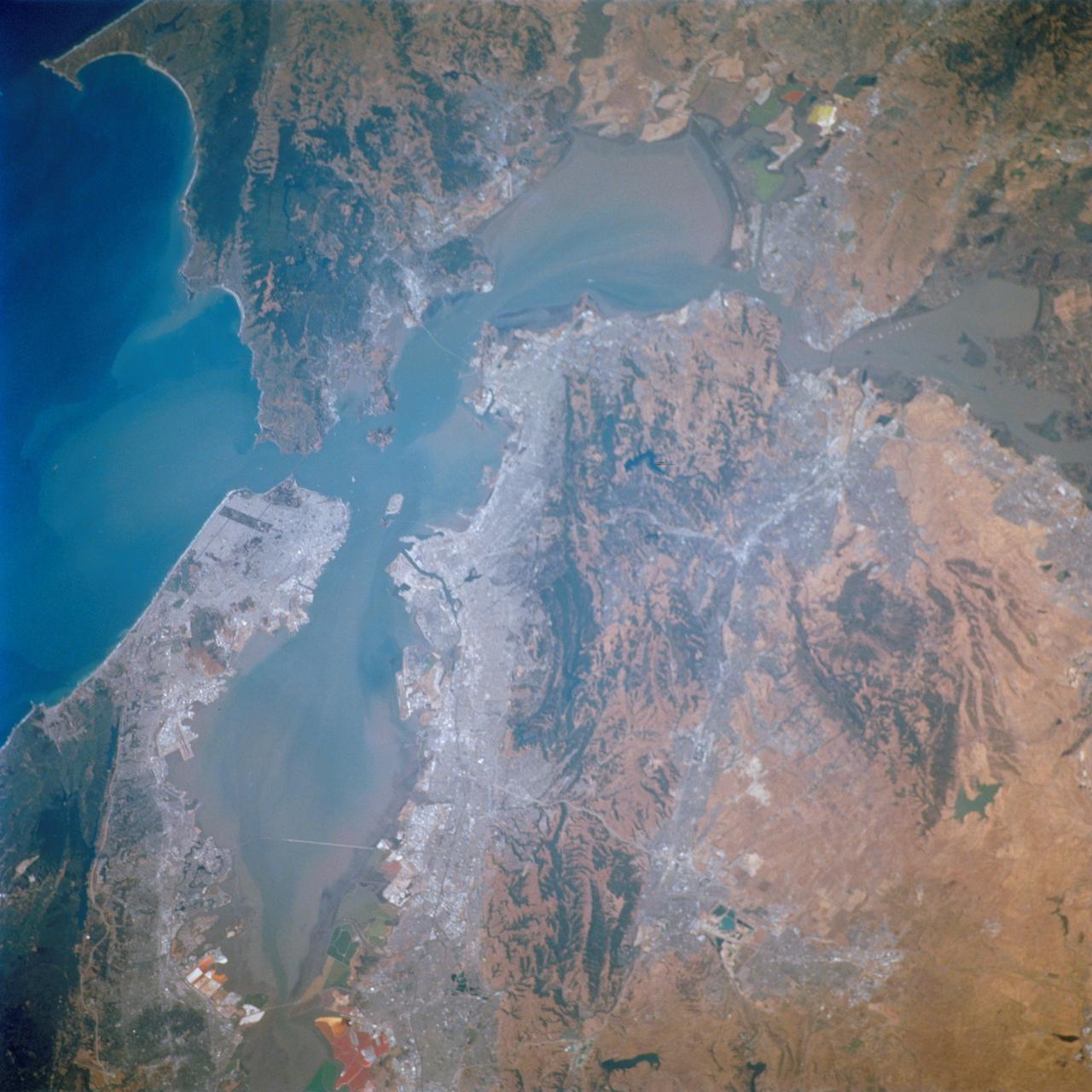 STS111-712-028 (5-19 June 2002) --- This photo featuring the San Francisco Bay area in California was photographed by one of the STS-111 crewmembers aboard the Space Shuttle Endeavour. The gray urban footprint of San Francisco, Oakland, San Jose, and the surrounding suburbs contrasts strongly with the brown and green vegetation in the hillsides. At the top and bottom of the picture the green, red and yellow pools are impoundments and salt evaporation ponds. The Gateway to Astronaut Photography of Earth (link to http://eol.jsc.nasa.gov/sseop/) provides searchable access to other photographs of Earth taken by astronauts.