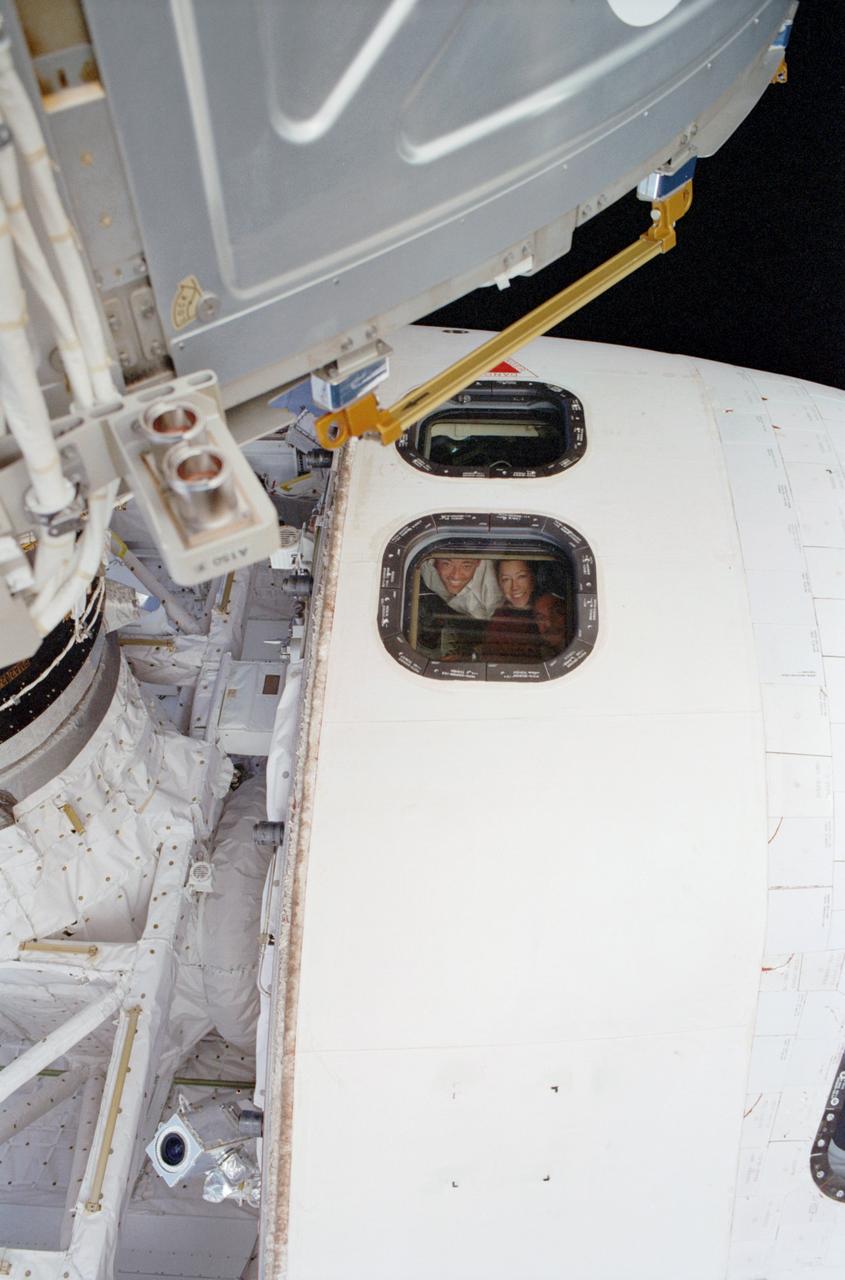 STS112-304-005 (12 October 2002) --- This scene, showing a portion of the forward section of the Space Shuttle Atlantis, was photographed by one of the space walking astronauts. Astronauts Jeffrey S. Ashby, STS-112 mission commander; Pamela A. Melroy, pilot; and cosmonaut Fyodor N. Yurchikhin, mission specialist, can be seen through an overheard aft flight deck window. Yurchikhin represents Rosaviakosmos.