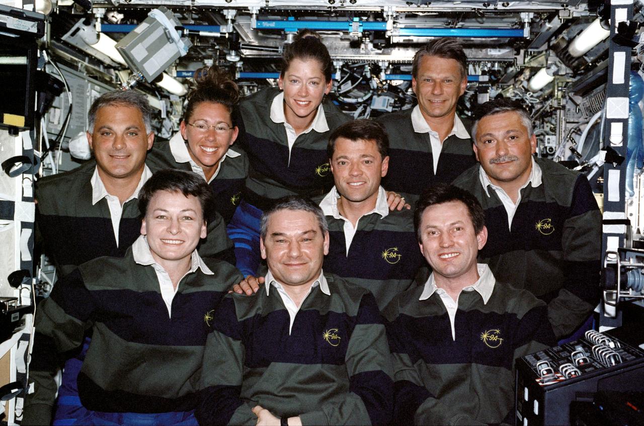 STS112-331-031 (13 October 2002) --- The Expedition Five and STS-112 crews assemble for a group photo in the Destiny laboratory on the International Space Station (ISS). From the left, front row, are astronaut Peggy A. Whitson, Expedition Five flight engineer; cosmonauts Valery G. Korzun and Sergei Y. Treschev, Expedition Five mission commander and flight engineer, respectively. From the left, back row, are astronauts David A. Wolf, Sandra H. Magnus, both STS-112 mission specialists; Pamela A. Melroy, Jeffrey S. Ashby, STS-112 pilot and mission commander, respectively; Piers J. Sellers and cosmonaut Fyodor N. Yurchikhin, both STS-112 mission specialists. Korzun, Treschev and Yurchikhin represent Rosaviakosmos.