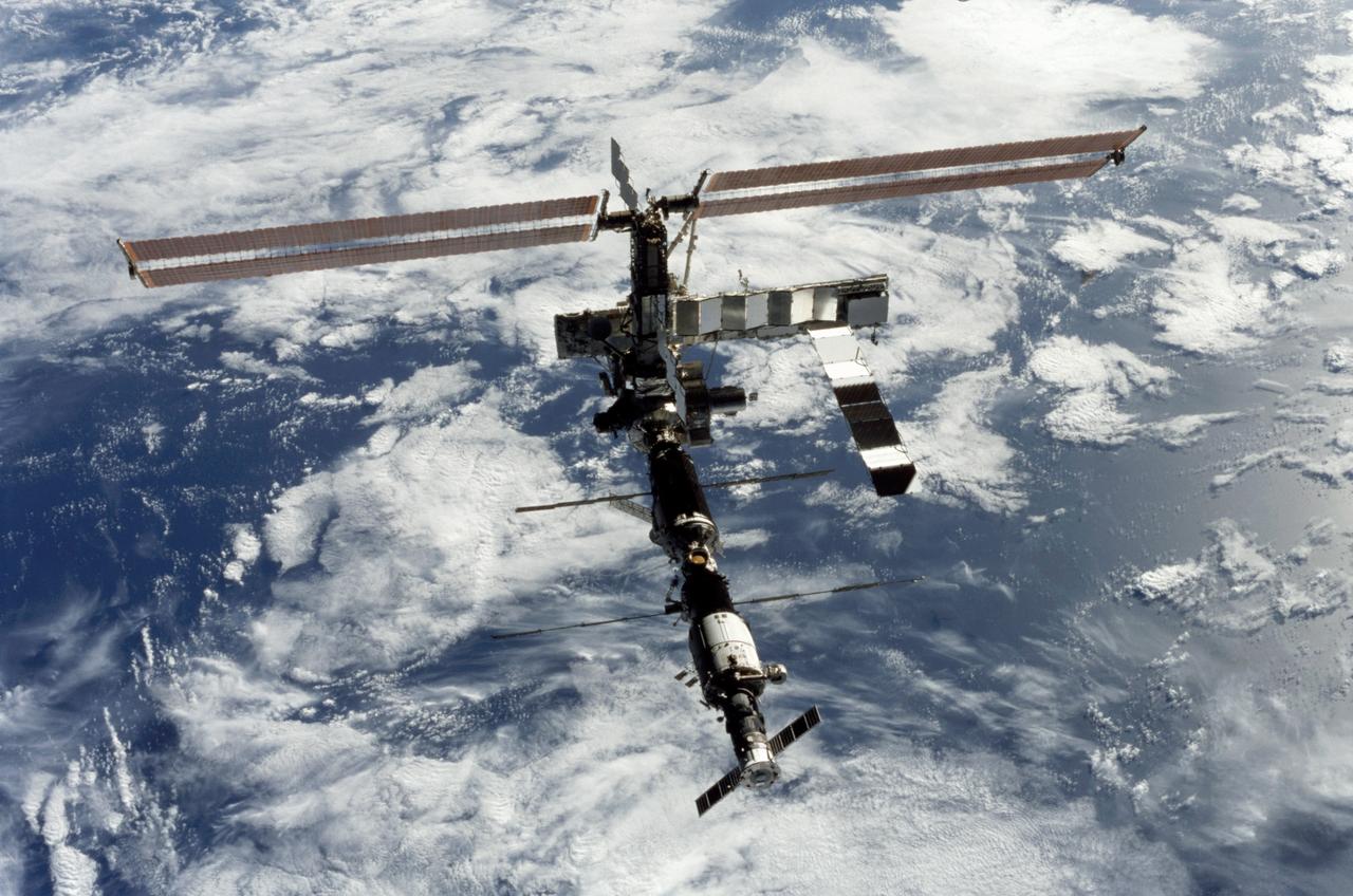 STS112-375-033 (16 October 2002) --- Backdropped by a blue and white Earth, this full view of the International Space Station (ISS) was photographed by a crewmember on board the Space Shuttle Atlantis following the undocking of the two spacecraft. Atlantis pulled away from the complex at 8:13 a.m. (CDT) on October 16, 2002.