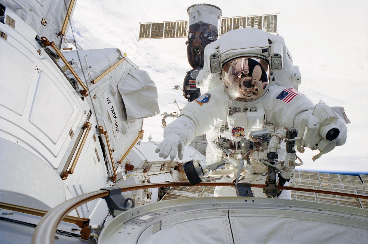 STS113-305-007 (26 November 2002) --- Astronaut John B. Herrington, STS-113 mission specialist, participates in the mission&#0146;s first spacewalk. The opened hatch of the Quest Airlock can be seen reflected in Herrington&#0146;s helmet visor.