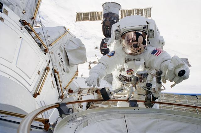 NASA image: Lopez-Alegria reflected in Herrington's helmet during STS-113 EVA 1