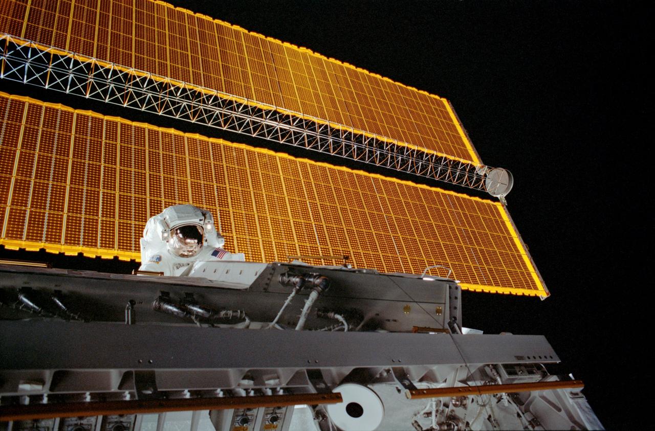 STS113-310-017 (28 November 2002) --- Astronaut John B. Herrington, STS-113 mission specialist, traverses along the newly installed Port One (P1) truss on the International Space Station (ISS) during the mission&#0146;s second scheduled spacewalk. One of the station&#0146;s main solar arrays is behind Herrington.