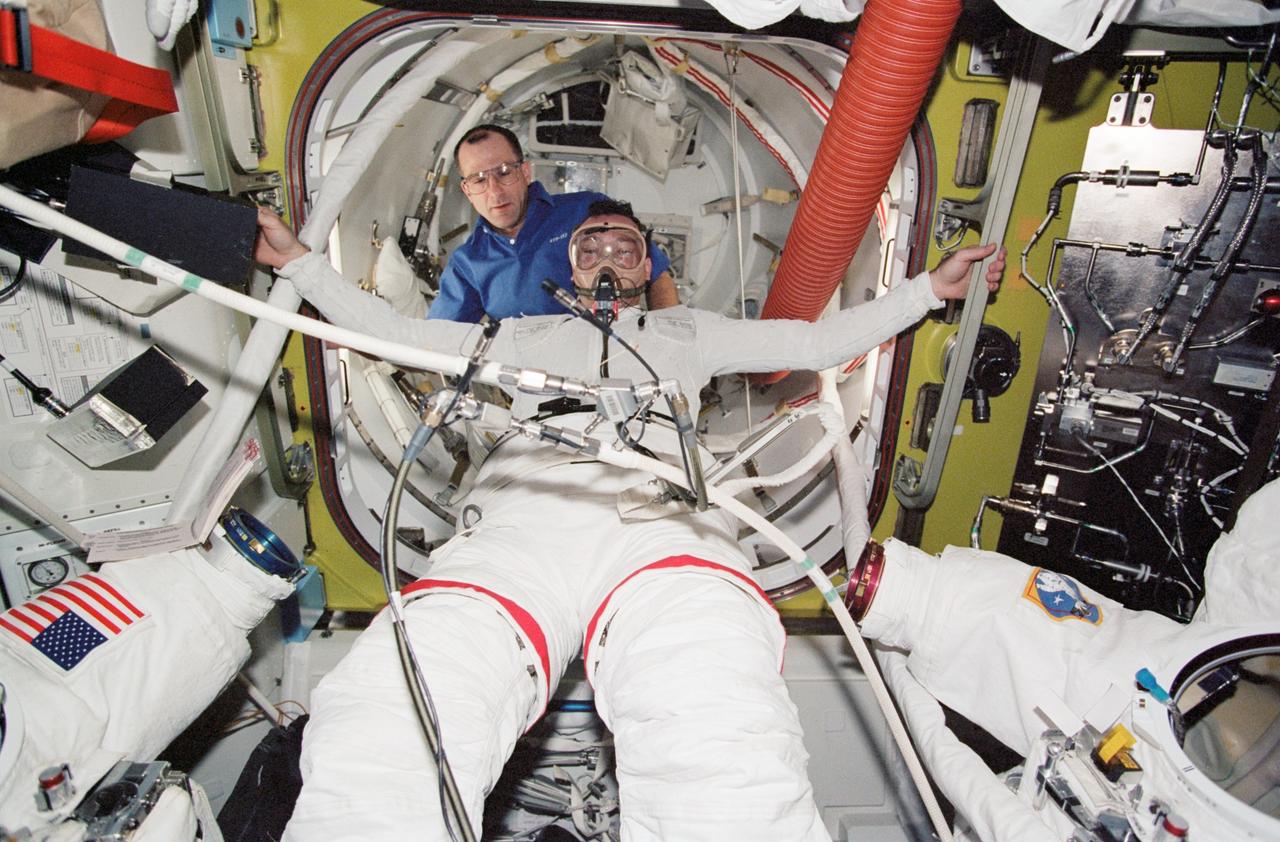 STS113-340-015 (28 November 2002) --- Astronaut Michael E. Lopez-Alegria, STS-113 mission specialist, is photographed in the midst of a pre-breathe exercise in preparation for the mission&#0146;s second session of extravehicular activity (EVA) in the Quest Airlock on the International Space Station (ISS). Astronaut Donald R. Pettit, Expedition Six NASA ISS science officer, assisted Lopez-Alegria.