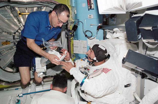 NASA image: Herrington and Pettit during STS-113 EVA 2 EMU don in Quest A/L