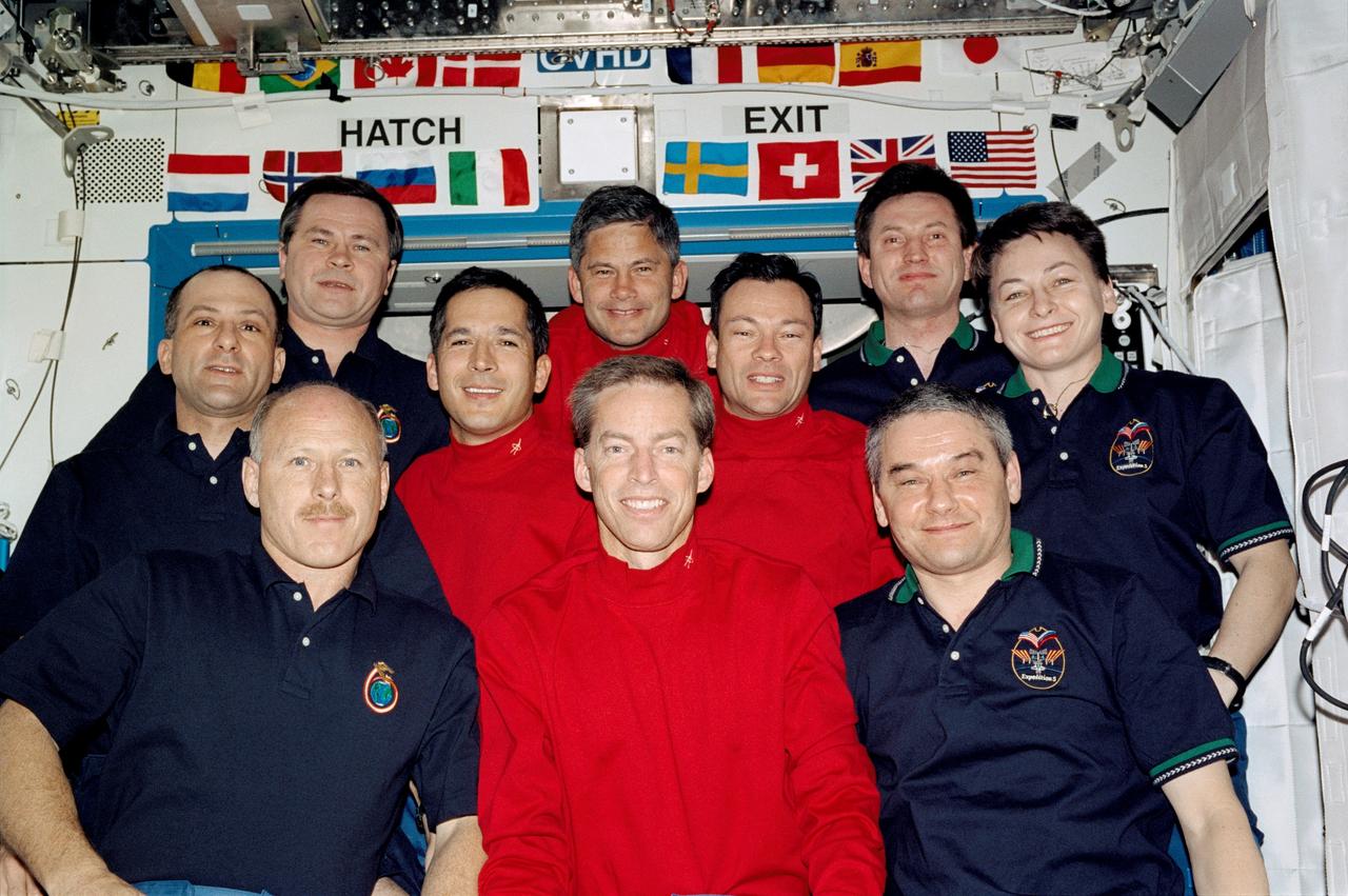 STS113-342-006 (29 November 2002) --- The STS-113 (red shirts), Expedition Five (right) and Expedition Six crewmembers (left) gathered for a group photo in the Destiny laboratory on the International Space Station (ISS). The STS-113 crew, front to back, are astronauts James D. Wetherbee, mission commander; John B. Herrington (left), Michael E. Lopez-Alegria, mission specialists; and Paul S. Lockhart, pilot. The Expedition Six crew, front to back, are astronauts Kenneth D. Bowersox, mission commander; Donald R. Pettit, NASA ISS science officer; and cosmonaut Nikolai M. Budarin, flight engineer. The Expedition Five crew, front to back, are cosmonaut Valery G. Korzun, mission commander; astronaut Peggy A. Whitson, NASA ISS science officer; and cosmonaut Sergei Y. Treschev, flight engineer. Korzun, Treschev and Budarin represent Rosaviakosmos.