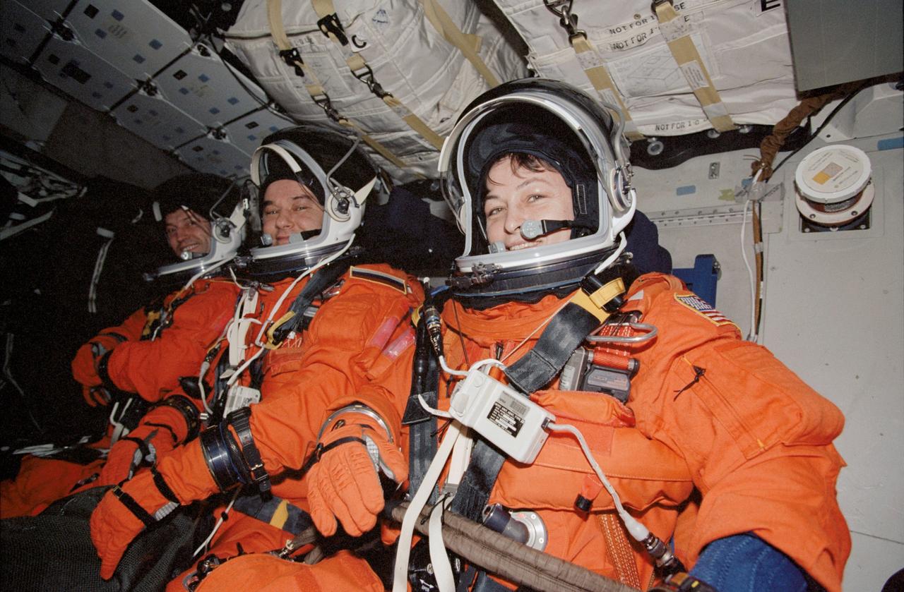 STS113-346-022 (7 December 2002) --- The Expedition Five crewmembers, attired in their shuttle launch and entry suits, are seated on the middeck of the Space Shuttle Endeavour in preparation for landing at Kennedy Space Center, Florida. From front to back are astronaut Peggy A. Whitson, NASA ISS science officer; cosmonauts Valery G. Korzun, mission commander; and Sergei Y. Treschev, flight engineer. Korzun and Treschev represent Rosaviakosmos.