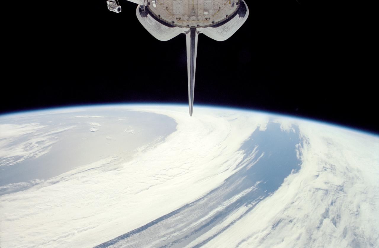 STS113-348-001 (23 November – 7 December 2002) --- The horizon of a blue and white Earth and the blackness of space form the backdrop for this view of Space Shuttle Endeavour’s vertical stabilizer.