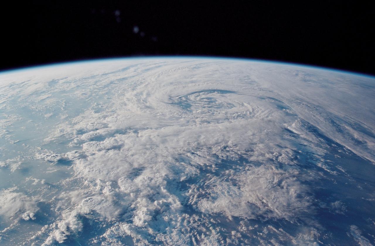 STS113-348-012  (3 December 2002) ---  The STS-113 crewmembers used a 35mm still camera to record this image of  a mid latitude storm system.  The counter-clockwise swirl shows that this is a northern hemisphere storm.  The storm was northeast of the Mediterranean Sea, covering the Balkans and western Turkey.  The view was taken looking northwest in the early afternoon of Dec 3, 2002.