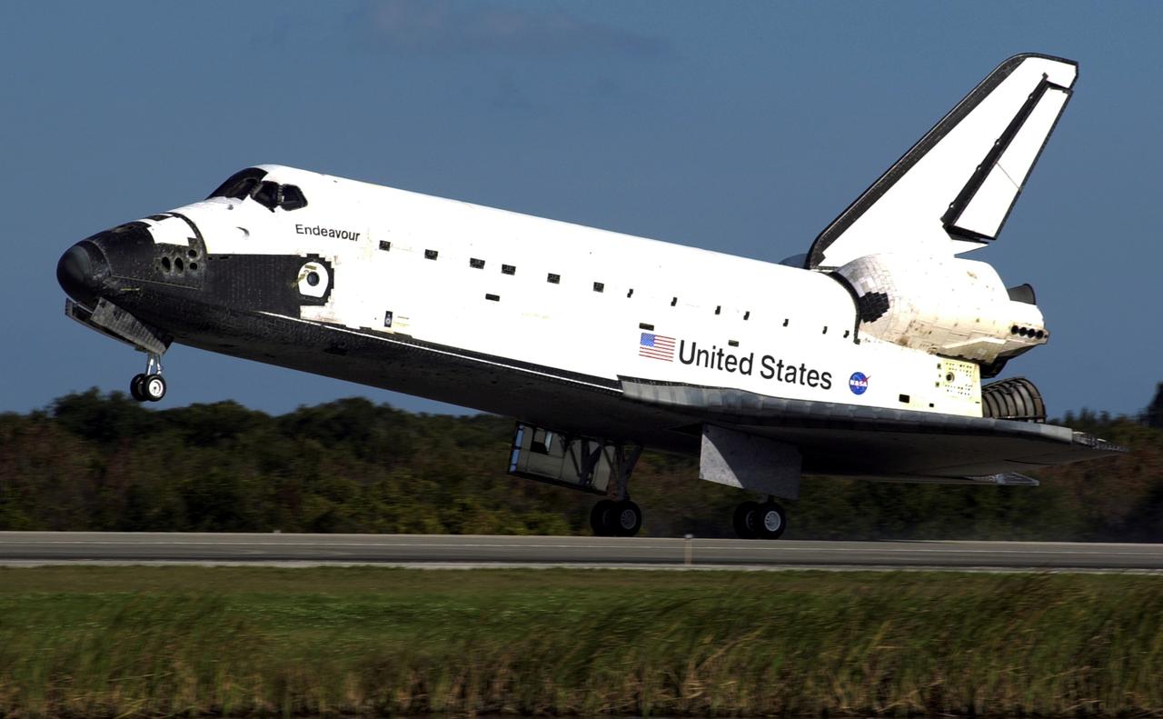 STS113-S-021 (7 December 2002) --- The main landing gear of Space Shuttle Endeavour touches down on runway 33 at the KSC landing facility, completing the nearly 14-day STS-113 mission to the International Space Station (ISS). Astronaut James D. Wetherbee, mission commander, eased Endeavour to a textbook landing on runway 33 at the Florida spaceport at 2:37 p.m. (EST) on December 7, 2002. The landing completed a 5.74-million mile mission that saw successful delivery and installation of the Port One (P1) truss on the orbital outpost.