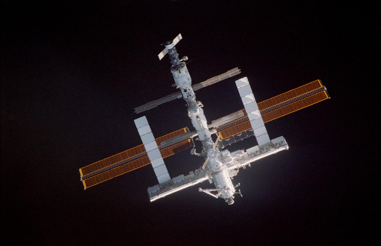 STS114-304-015 (28 July 2005) --- Backdropped by the blackness of space, the International Space Station was photographed by an STS-114 crewmember aboard Space Shuttle Discovery during rendezvous and docking operations. Discovery docked with the Station at 6:18 a.m. (CDT) on Thursday July 28, 2005.