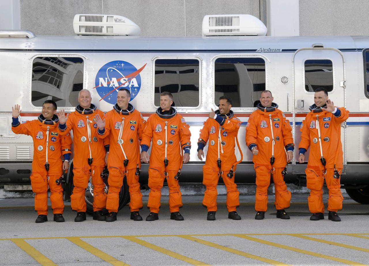 STS119-S-008 (15 March 2009) --- After suiting up, the STS-119 crewmembers pause alongside the Astrovan to wave farewell to onlookers before heading for launch pad 39A for the launch of Space Shuttle Discovery on the STS-119 mission. From the right are astronauts Lee Archambault, commander; Tony Antonelli, pilot; Joseph Acaba, Steve Swanson, Richard Arnold, John Phillips and Japan Aerospace Exploration Agency’s Koichi Wakata, all mission specialists. Wakata will join Expedition 18 in progress to serve as a flight engineer aboard the International Space Station. Discovery will deliver the final pair of power-generating solar array wings and the S6 truss segment. Installation of S6 will signal the station's readiness to house a six-member crew for conducting increased science.