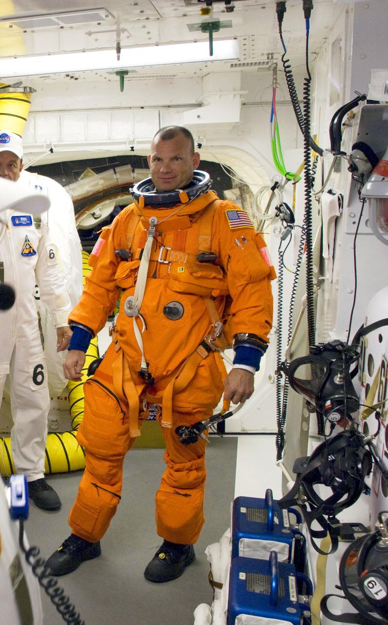 STS119-S-012 (15 March 2009) --- Astronaut Tony Antonelli, STS-119 pilot, attired in his shuttle launch and entry suit (with harness and parachute pack), is pictured in the White Room on launch pad 39A at NASA's Kennedy Space Center in Florida, before crawling through the open hatch into Space Shuttle Discovery. The White Room is at the end of the orbiter access arm on the fixed service structure and provides access into the shuttle. Liftoff is scheduled for 7:43 p.m. (EDT) on March 15, 2009.