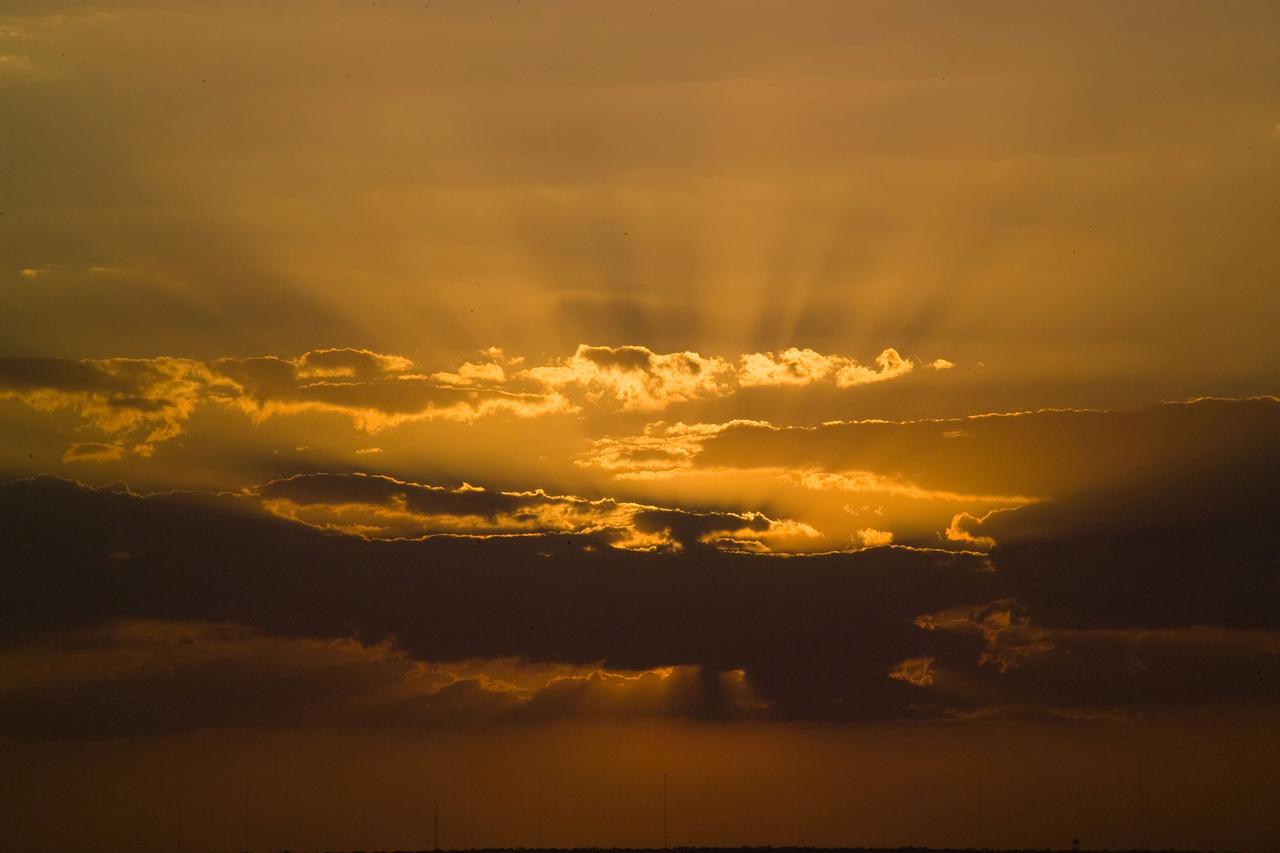 STS119-S-025 (15 March 2009) --- The setting sun paints the clouds over NASA's Kennedy Space Center in Florida before the launch of Space Shuttle Discovery on the STS-119 mission. Liftoff is scheduled for 7:43 p.m. (EDT) on March 15, 2009.