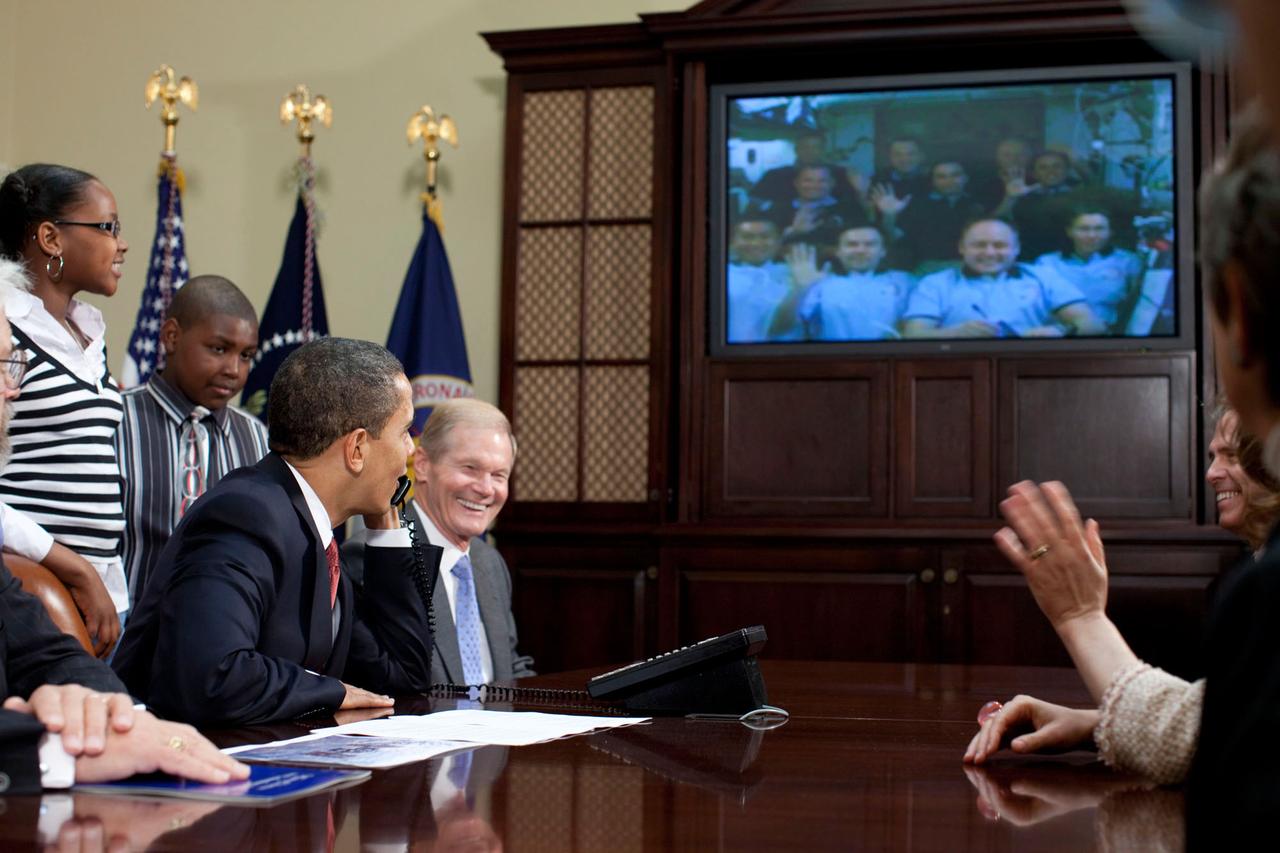 President Barack Obama is joined by members of Congress, including former astronaut Sen. Bill Nelson, right, and school children as he talks Tuesday, March 24, 2009, with astronauts on the International Space Station from the Roosevelt Room at the White House. (White House Photo/Pete Souza)