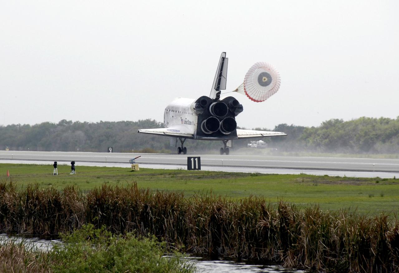 STS119-S-044 (28 March 2009) --- Space Shuttle Discovery?s drag chute is deployed as the spacecraft rolls toward wheels stop on Runway 15 of the Shuttle Landing Facility at NASA's Kennedy Space Center, concluding the 13-day, 5.3-million mile journey of the STS-119 mission to the International Space Station. Onboard are NASA astronauts Lee Archambault, commander; Tony Antonelli, pilot; Steve Swanson, Richard Arnold, Joseph Acaba, John Phillips and Sandra Magnus, all mission specialists. The main landing gear touched down at 3:13:17 p.m. (EDT) on March 28, 2009. The nose gear touched down at 3:13:40 p.m. and wheels stop was at 3:14:45 p.m. During the mission, Discovery?s crew delivered and installed the final pair of large power-generating solar array wings and the S6 truss segment to the starboard, or right, side of the station and accomplished important tasks to prepare the station for future upgrades and additions later this year.