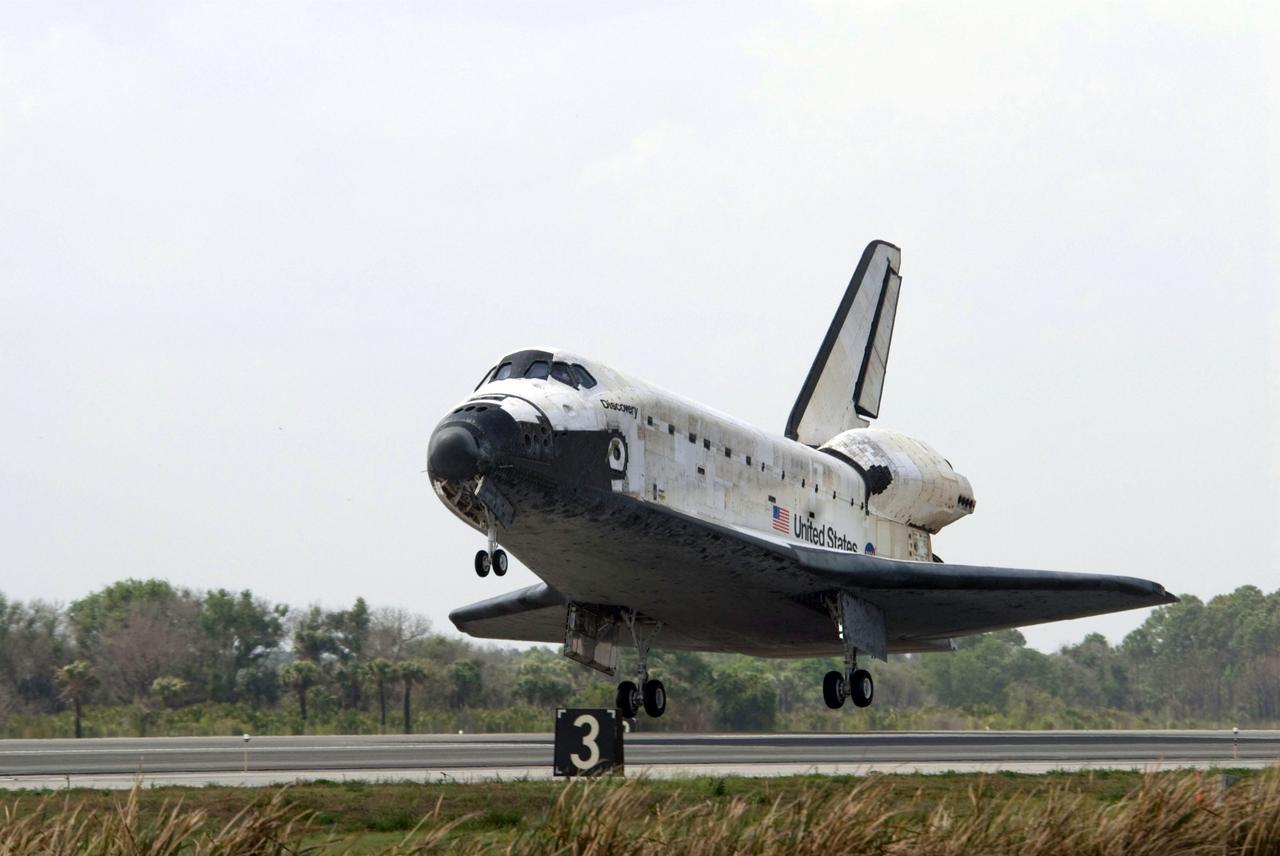 STS119-S-048 (28 March 2009) --- Space Shuttle Discovery approaches landing on Runway 15 of the Shuttle Landing Facility at NASA's Kennedy Space Center, concluding the 13-day, 5.3-million mile journey of the STS-119 mission to the International Space Station. Onboard are NASA astronauts Lee Archambault, commander; Tony Antonelli, pilot; Steve Swanson, Richard Arnold, Joseph Acaba, John Phillips and Sandra Magnus, all mission specialists. The main landing gear touched down at 3:13:17 p.m. (EDT) on March 28, 2009. The nose gear touched down at 3:13:40 p.m. and wheels stop was at 3:14:45 p.m. During the mission, Discovery?s crew delivered and installed the final pair of large power-generating solar array wings and the S6 truss segment to the starboard, or right, side of the station and accomplished important tasks to prepare the station for future upgrades and additions later this year.