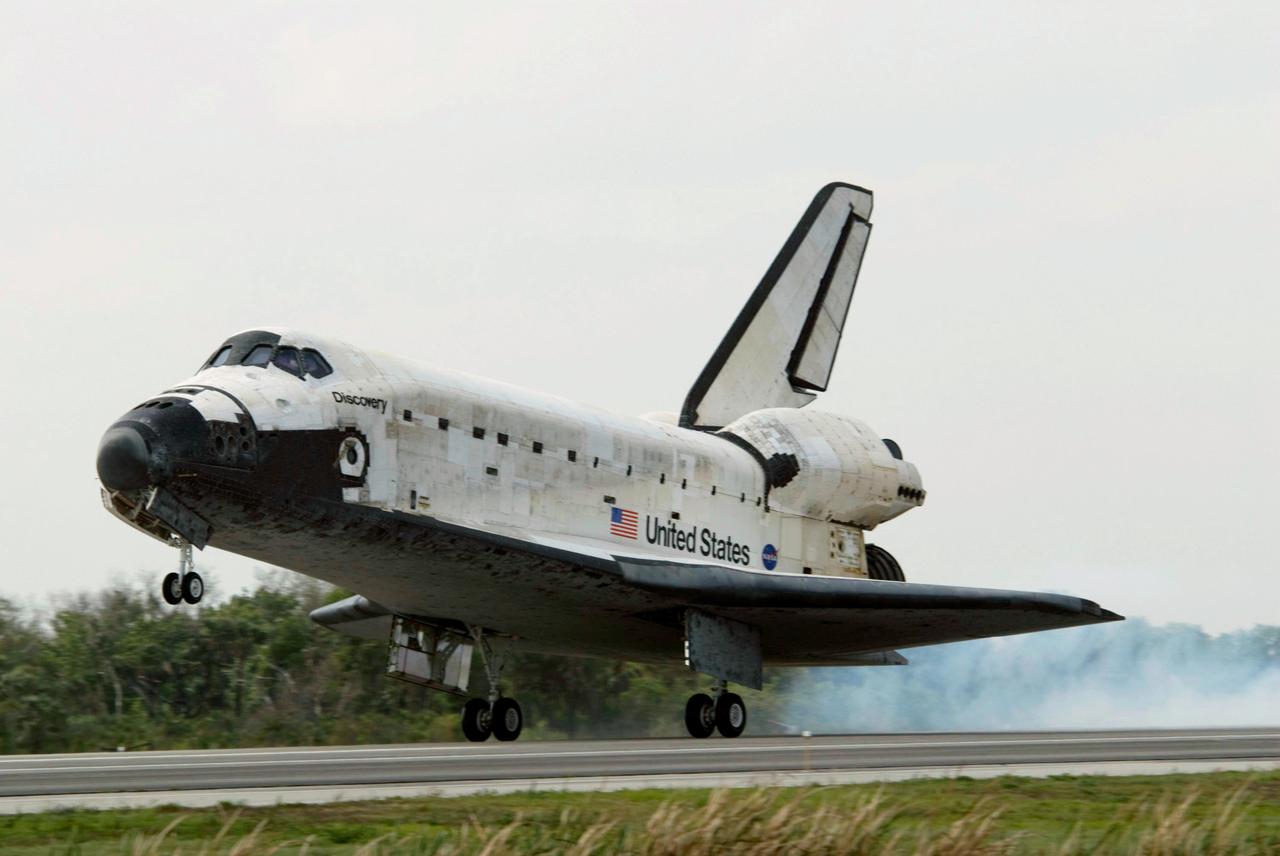 STS119-S-049 (28 March 2009) --- Space Shuttle Discovery touches down on Runway 15 of the Shuttle Landing Facility at NASA's Kennedy Space Center, concluding the 13-day, 5.3-million mile journey of the STS-119 mission to the International Space Station. Onboard are NASA astronauts Lee Archambault, commander; Tony Antonelli, pilot; Steve Swanson, Richard Arnold, Joseph Acaba, John Phillips and Sandra Magnus, all mission specialists. The main landing gear touched down at 3:13:17 p.m. (EDT) on March 28, 2009. The nose gear touched down at 3:13:40 p.m. and wheels stop was at 3:14:45 p.m. During the mission, Discovery?s crew delivered and installed the final pair of large power-generating solar array wings and the S6 truss segment to the starboard, or right, side of the station and accomplished important tasks to prepare the station for future upgrades and additions later this year.