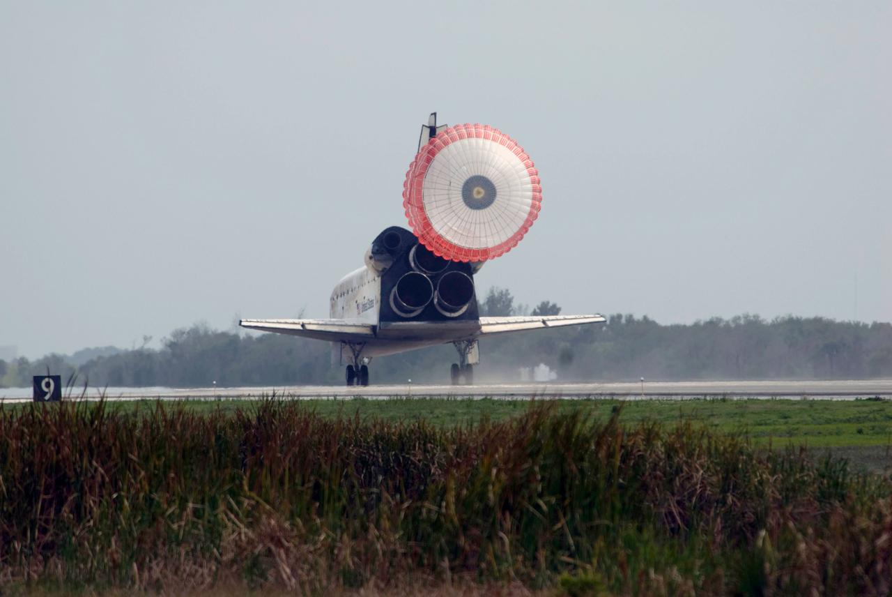 STS119-S-051 (28 March 2009) --- Space Shuttle Discovery?s drag chute is deployed as the spacecraft rolls toward wheels stop on Runway 15 of the Shuttle Landing Facility at NASA's Kennedy Space Center, concluding the 13-day, 5.3-million mile journey of the STS-119 mission to the International Space Station. Onboard are NASA astronauts Lee Archambault, commander; Tony Antonelli, pilot; Steve Swanson, Richard Arnold, Joseph Acaba, John Phillips and Sandra Magnus, all mission specialists. The main landing gear touched down at 3:13:17 p.m. (EDT) on March 28, 2009. The nose gear touched down at 3:13:40 p.m. and wheels stop was at 3:14:45 p.m. During the mission, Discovery?s crew delivered and installed the final pair of large power-generating solar array wings and the S6 truss segment to the starboard, or right, side of the station and accomplished important tasks to prepare the station for future upgrades and additions later this year.
